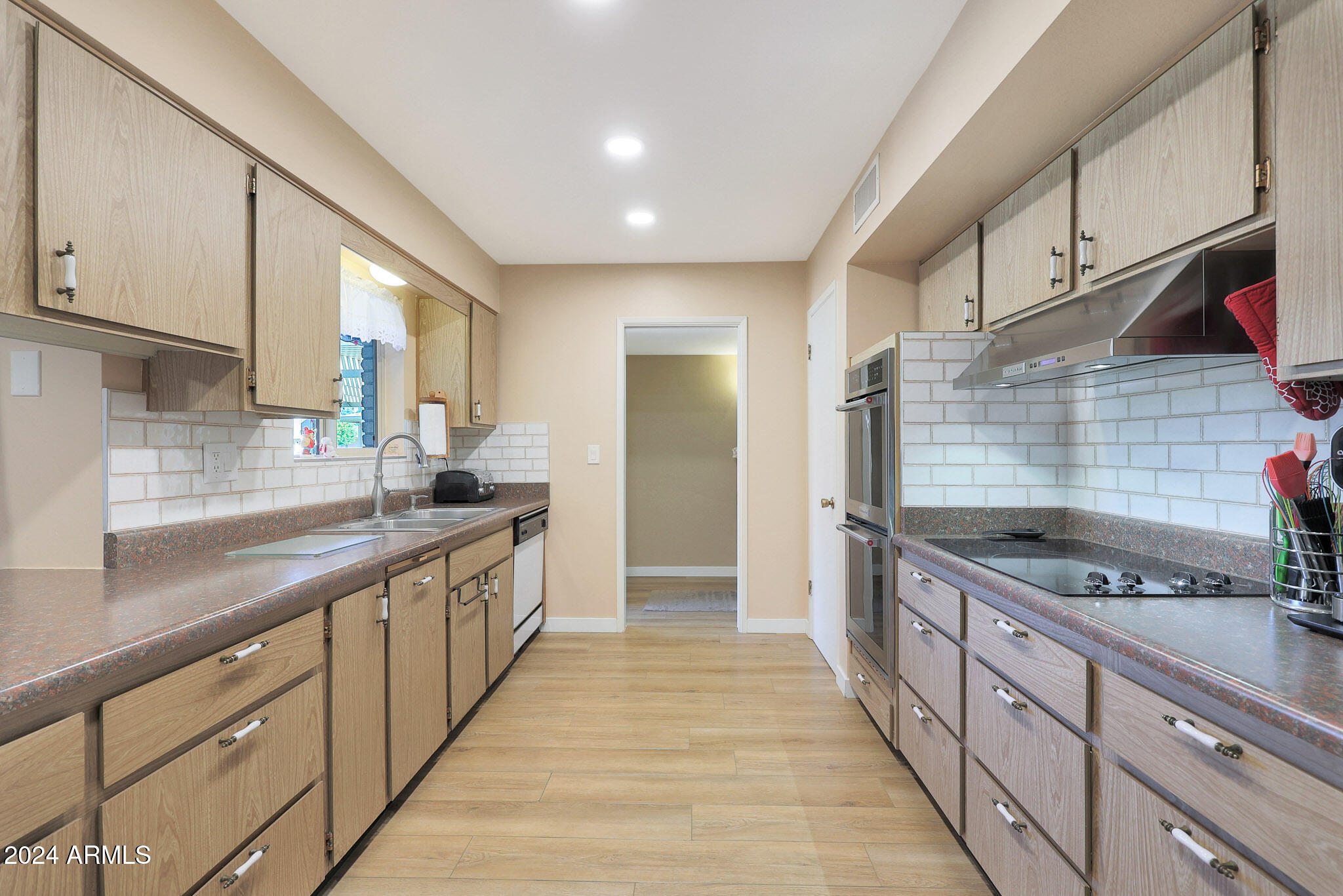10137 West Mountain View Road Sun City, AZ 85351 - Photo 15 of 34 a kitchen with stainless steel appliances granite countertop a sink and stove