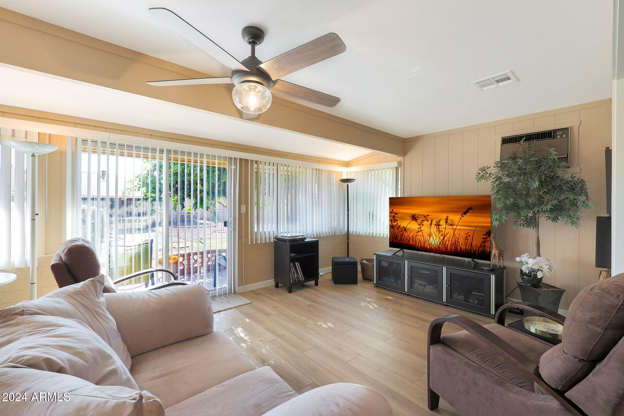 10137 West Mountain View Road Sun City, AZ 85351 - Photo 18 of 34 a living room with furniture and a flat screen tv