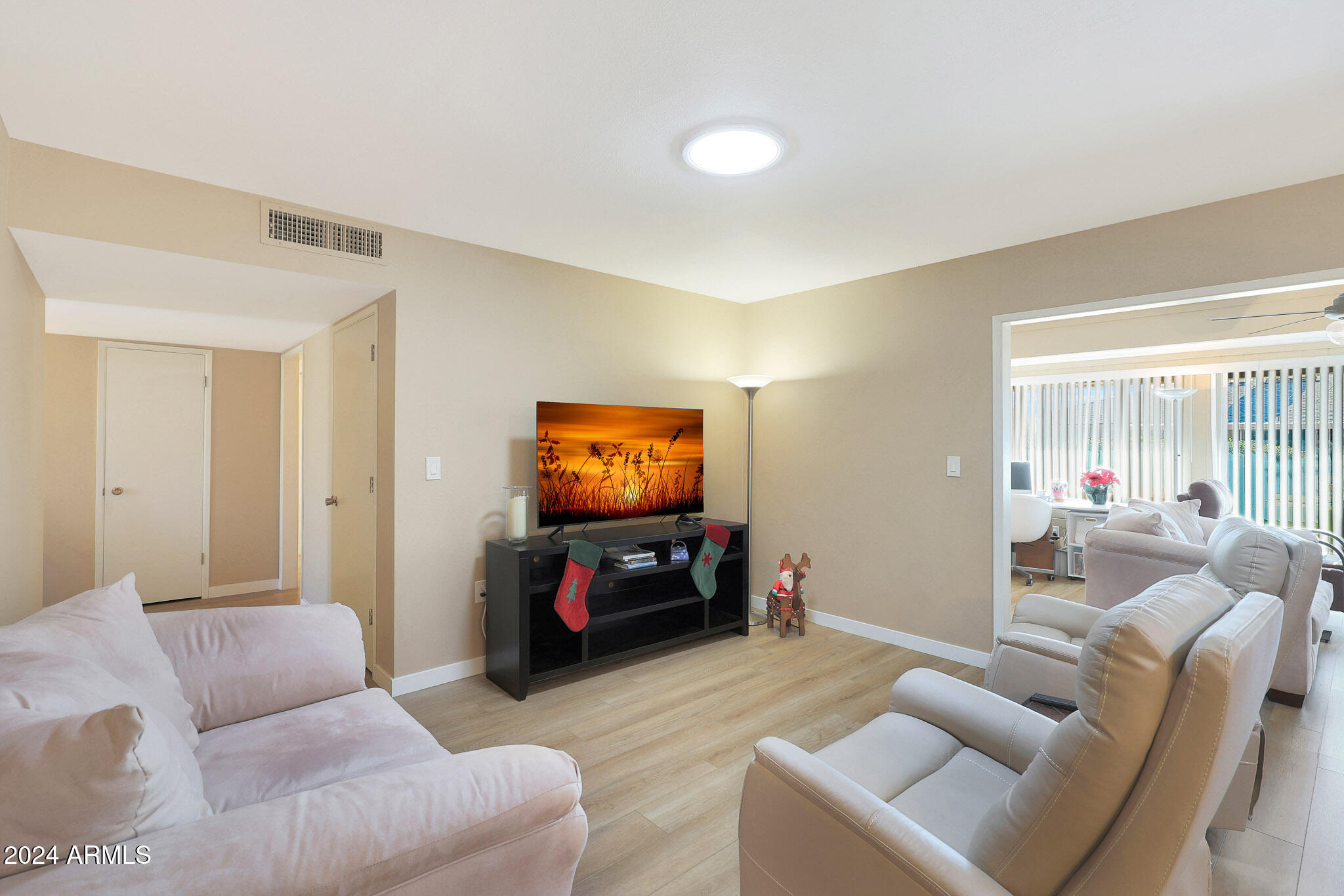 10137 West Mountain View Road Sun City, AZ 85351 - Photo 2 of 34 a living room with furniture and a flat screen tv