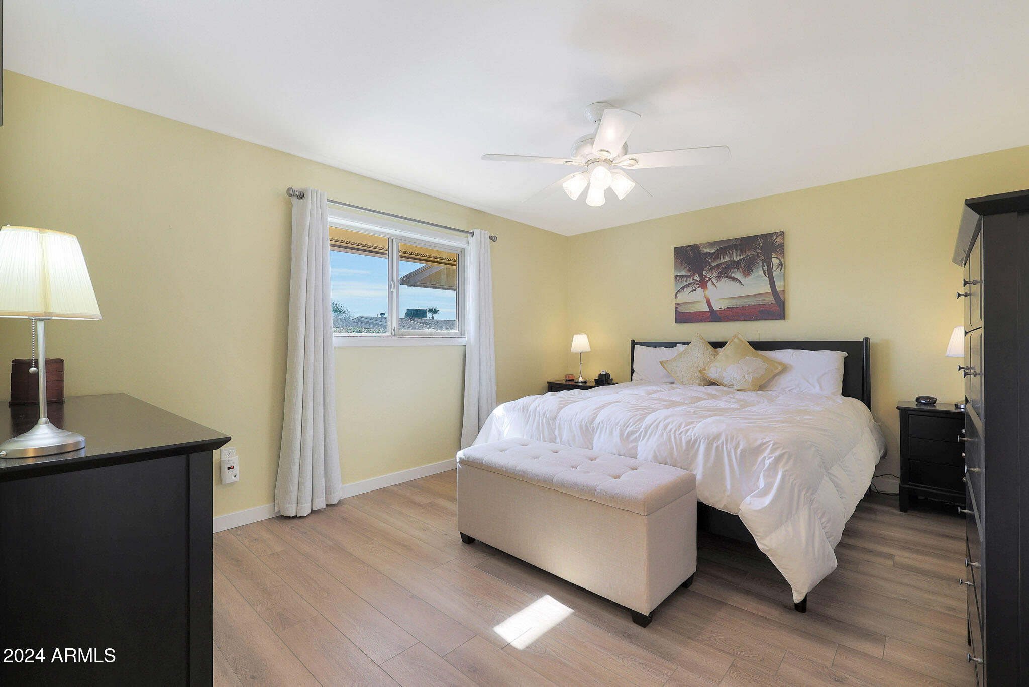10137 West Mountain View Road Sun City, AZ 85351 - Photo 22 of 34 a bedroom with a bed and a table