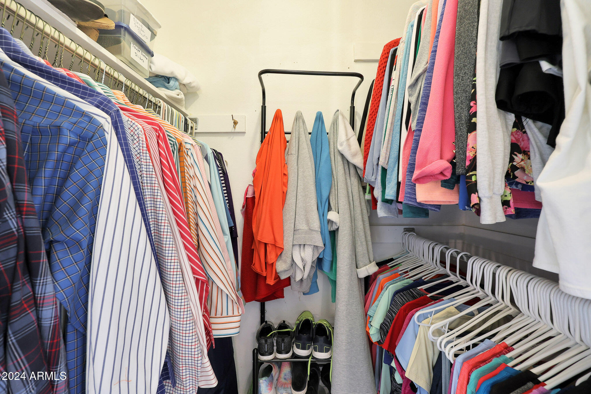 10137 West Mountain View Road Sun City, AZ 85351 - Photo 23 of 34 a view of walk in closet with clothes and shoes