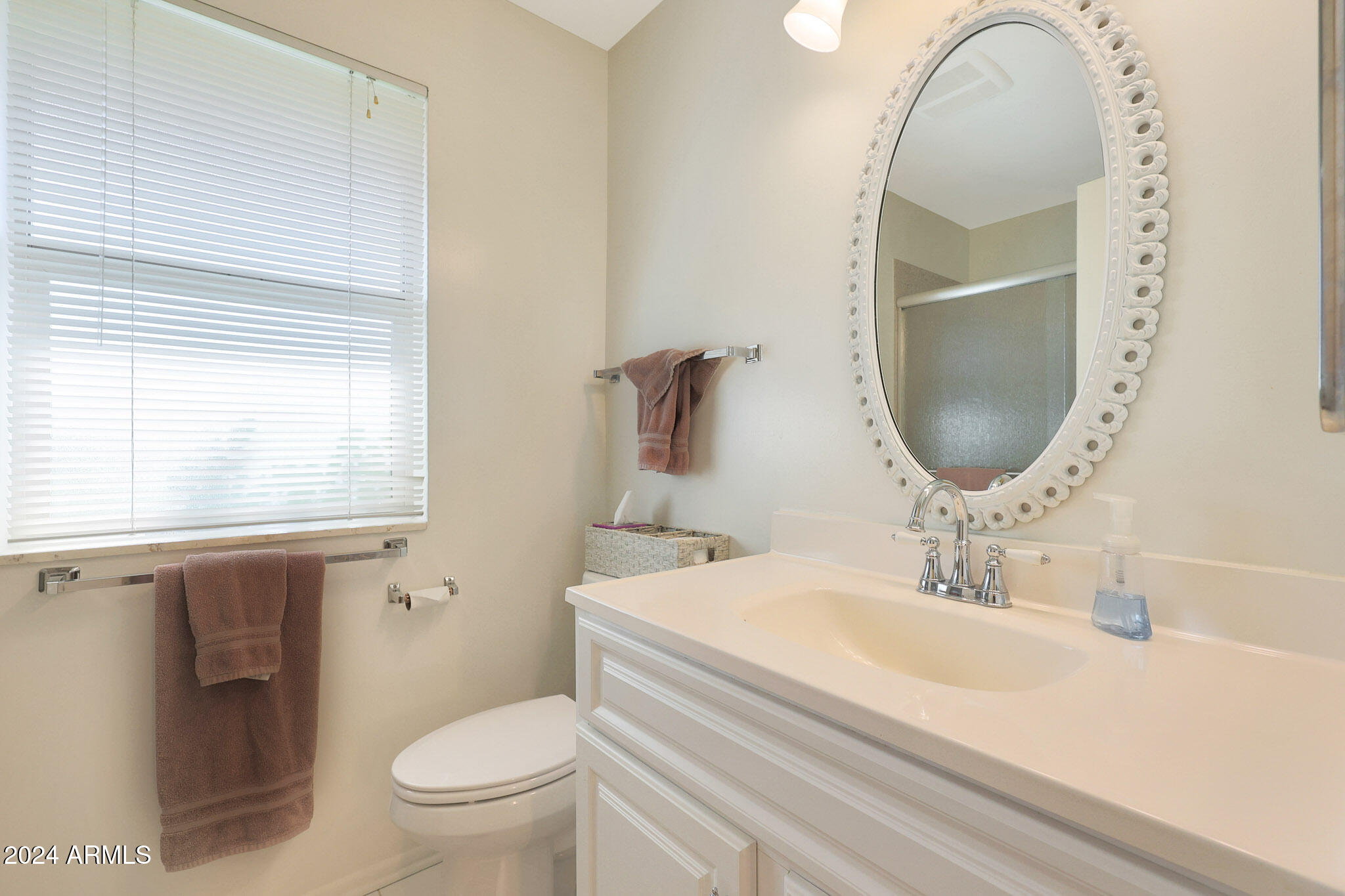 10137 West Mountain View Road Sun City, AZ 85351 - Photo 24 of 34 a bathroom with a sink and a mirror