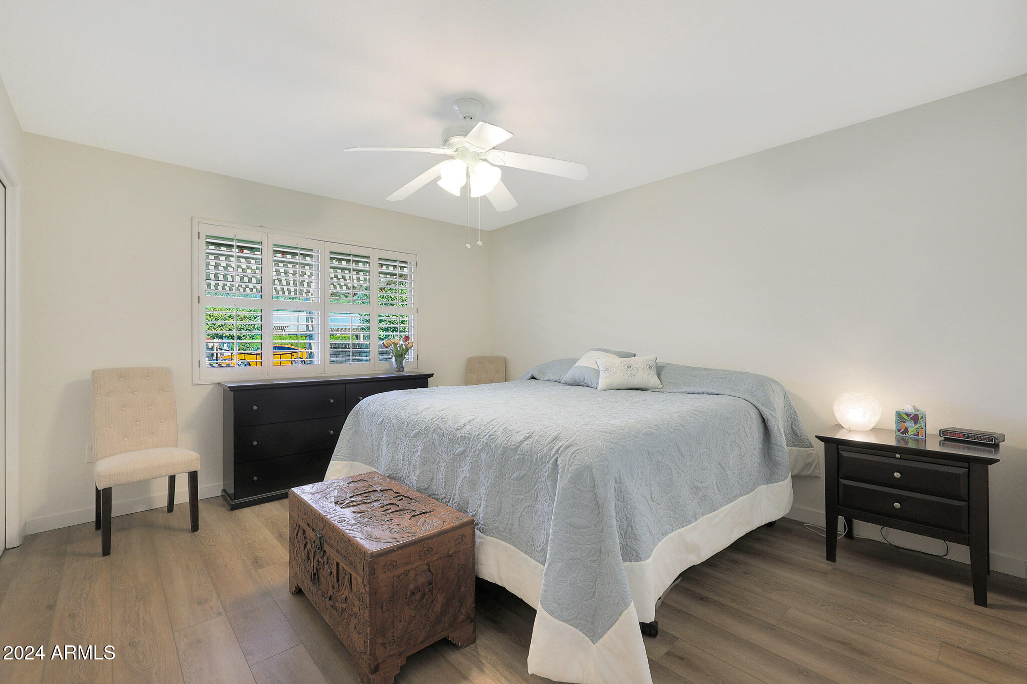 10137 West Mountain View Road Sun City, AZ 85351 - Photo 27 of 34 a bedroom with a bed window and a chair