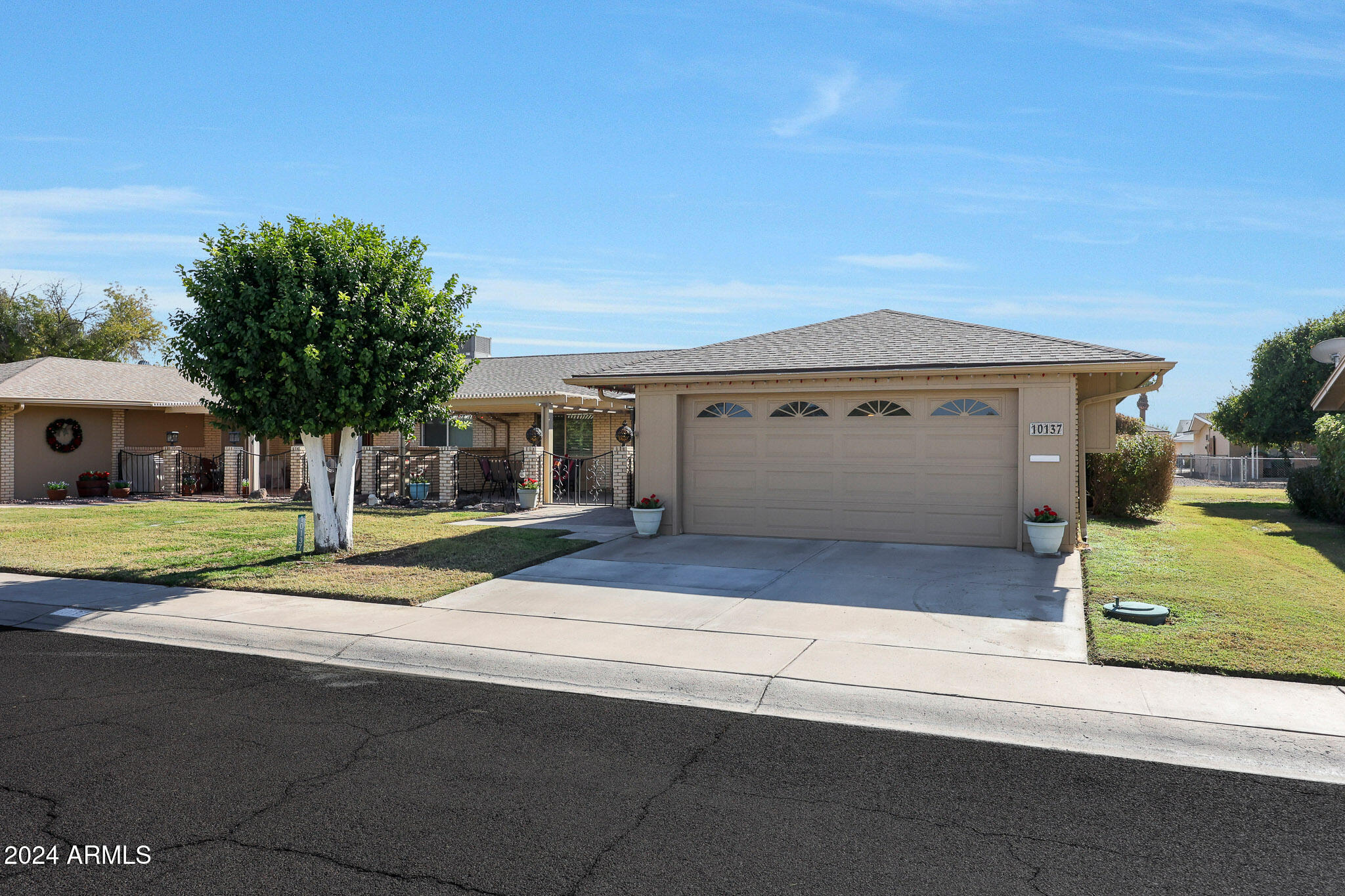 10137 West Mountain View Road Sun City, AZ 85351 - Photo 6 of 34 a front view of a house with a yard