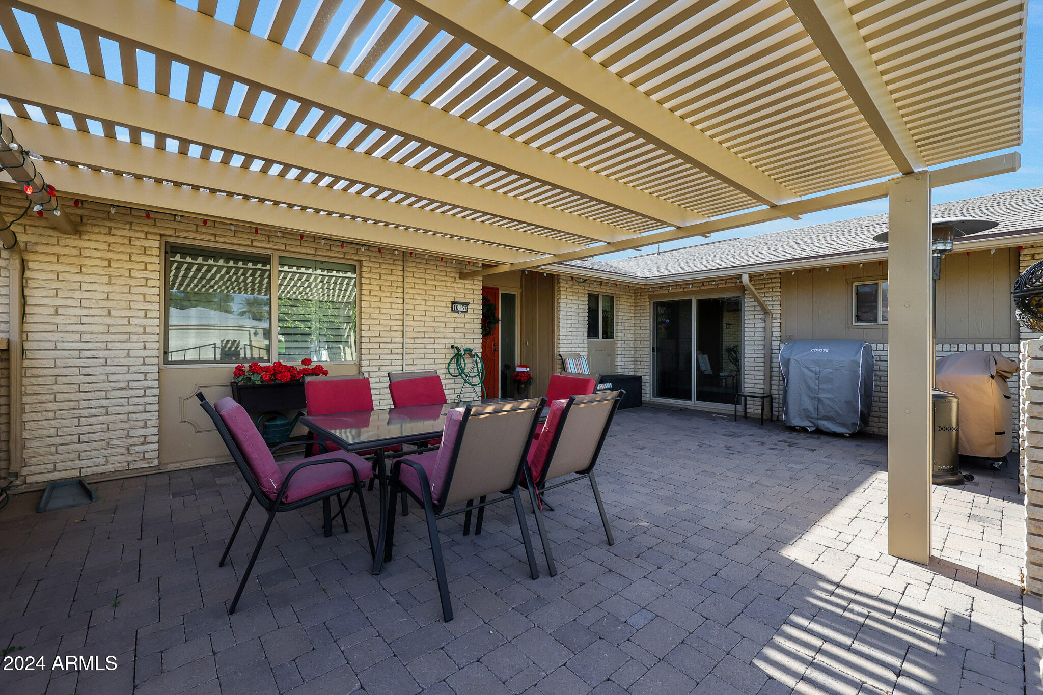 10137 West Mountain View Road Sun City, AZ 85351 - Photo 9 of 34 a view of a patio with a table and chairs and potted plants