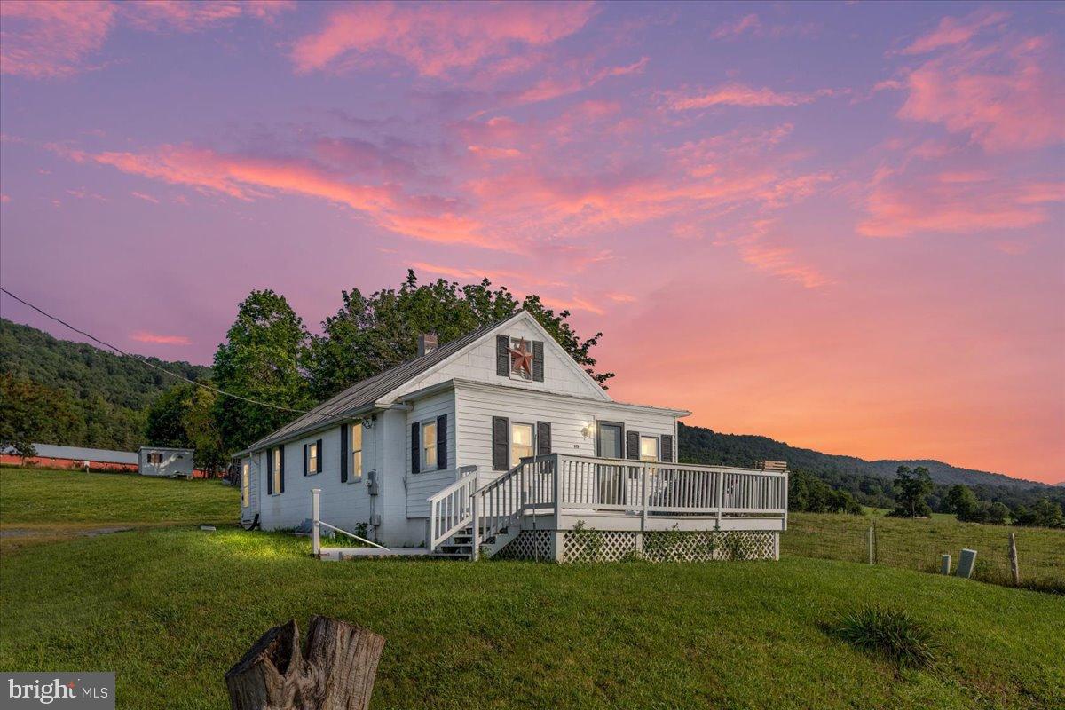 919 Ridge Hollow Road Edinburg, VA 22824 - Photo 1 of 35 Charming home under a vibrant sunset sky.