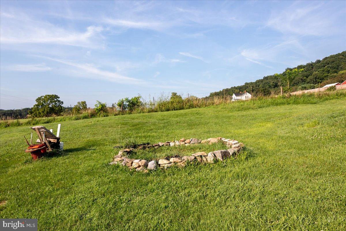 919 Ridge Hollow Road Edinburg, VA 22824 - Photo 25 of 35 Serene landscape with a rustic fire pit.