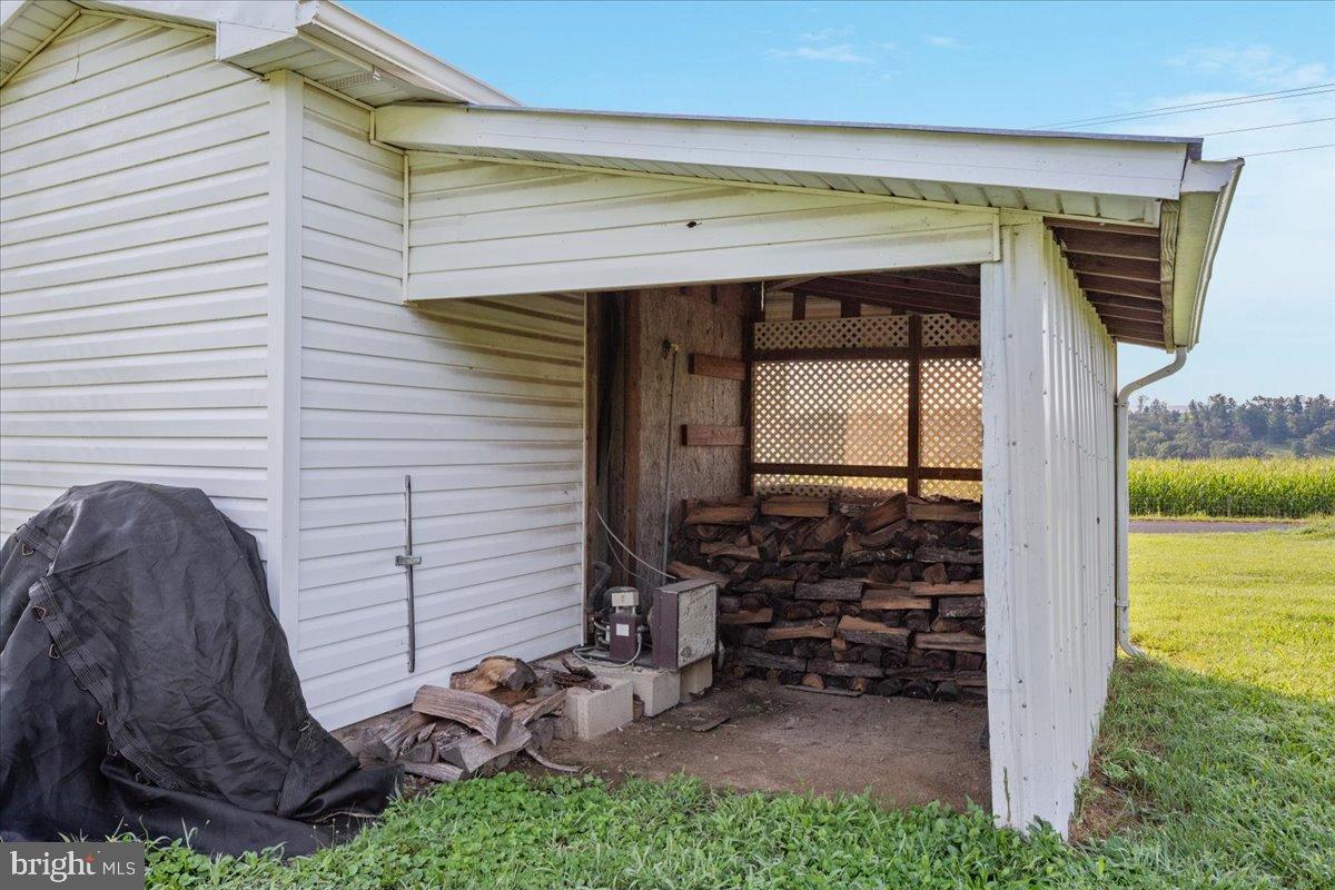 919 Ridge Hollow Road Edinburg, VA 22824 - Photo 27 of 35 Charming wood storage beside a cozy home.