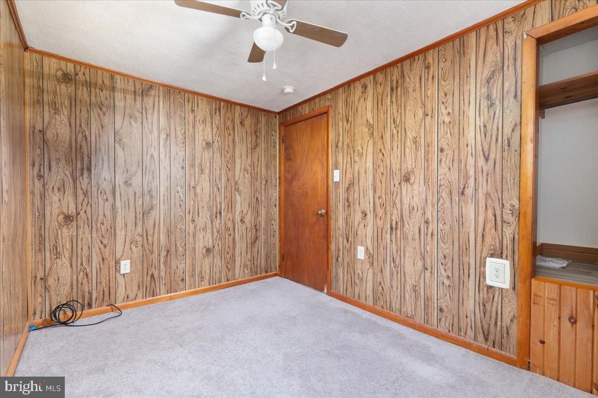 919 Ridge Hollow Road Edinburg, VA 22824 - Photo 32 of 35 Cozy room with rustic wood paneling.