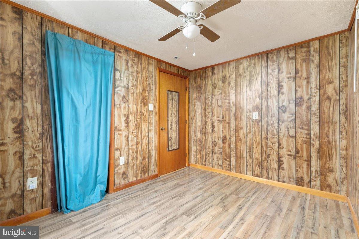 919 Ridge Hollow Road Edinburg, VA 22824 - Photo 35 of 35 Cozy room with rustic wood paneling.