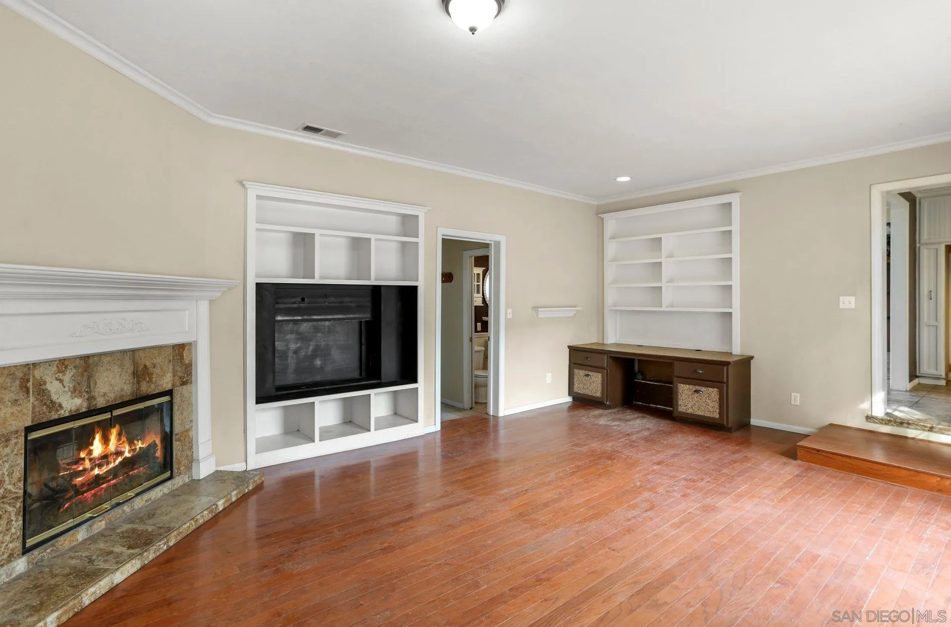 9255 Los Coches Road Lakeside, CA 92040 - Photo 13 of 34 an empty room with fireplace and wooden floor