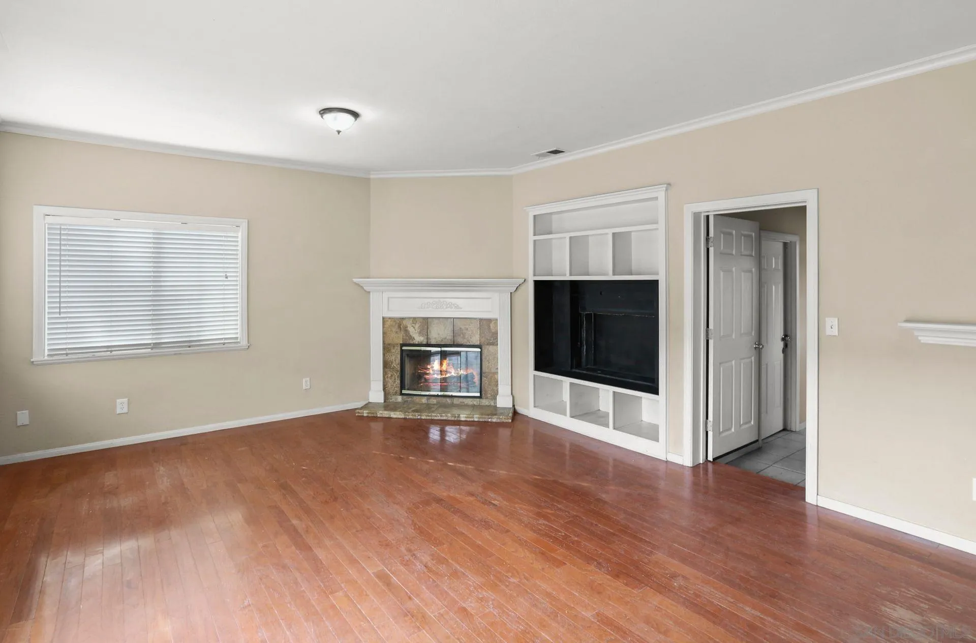 9255 Los Coches Road Lakeside, CA 92040 - Photo 14 of 34 a view of an empty room with window and wooden floor