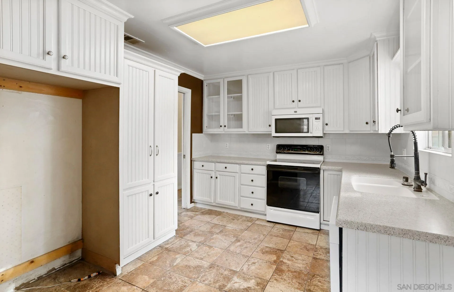 9255 Los Coches Road Lakeside, CA 92040 - Photo 17 of 34 a kitchen with granite countertop a stove sink and microwave