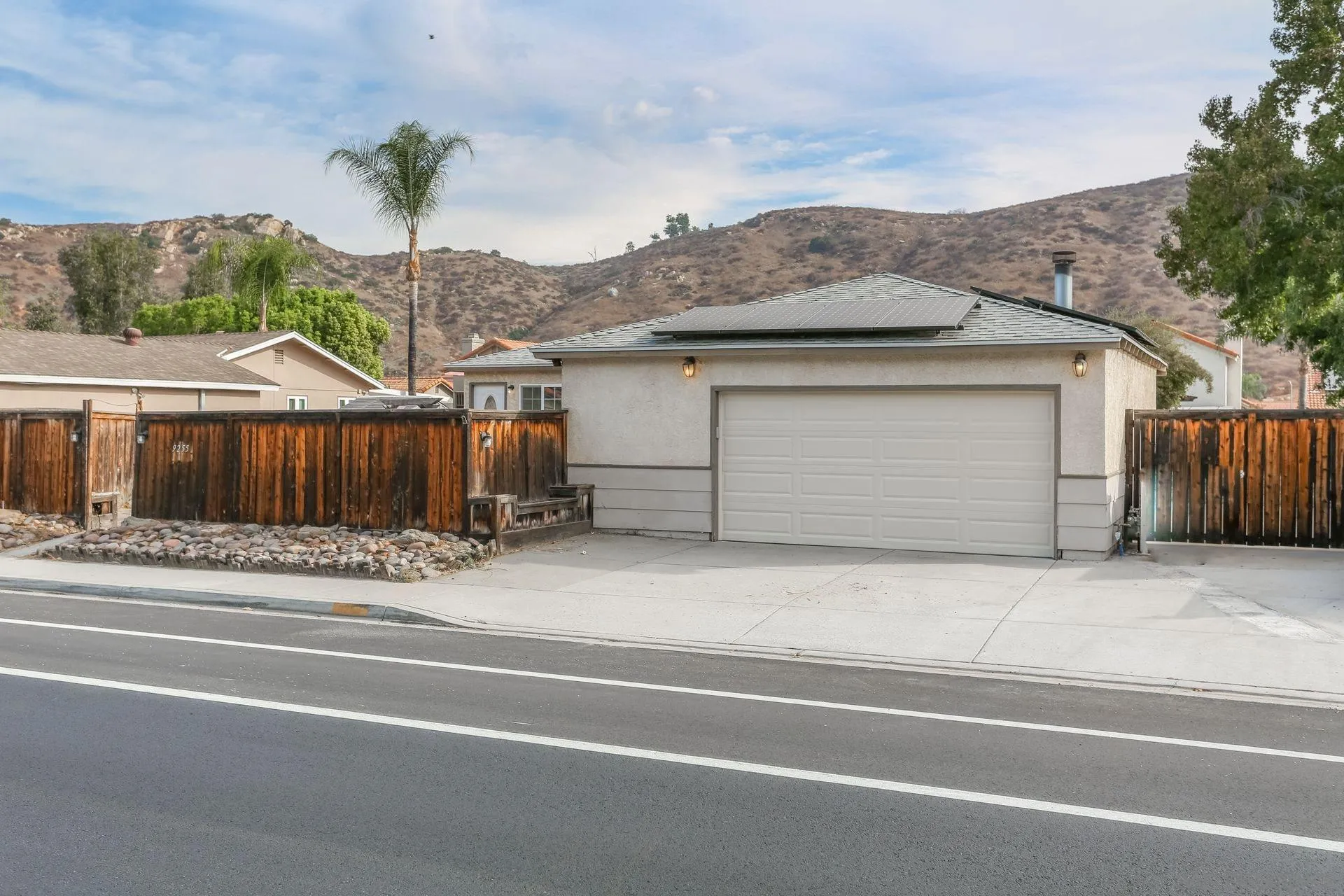 9255 Los Coches Road Lakeside, CA 92040 - Photo 3 of 34 a view of a house with a garden and parking area