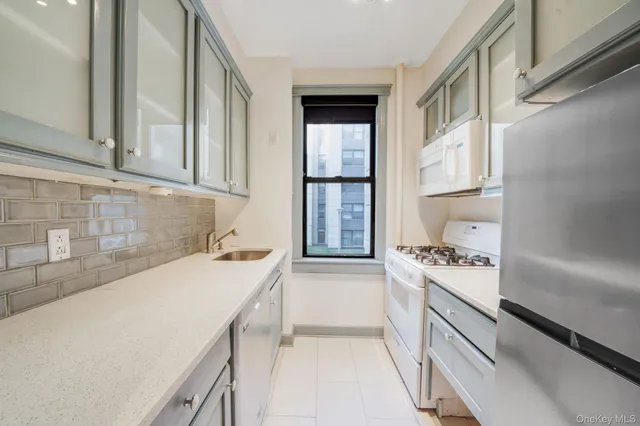 a kitchen with a sink a stove and cabinets