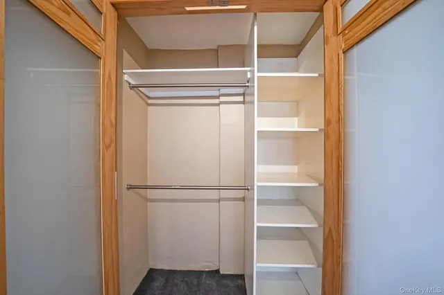 a bathroom with a sink a toilet a mirror and shower