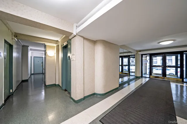a view of a big room with windows and chandelier