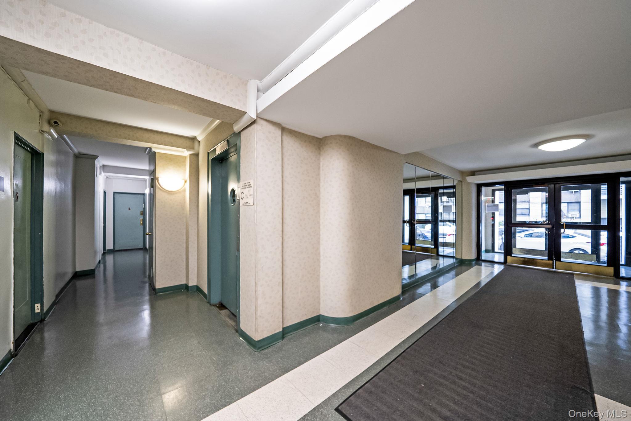 98-33 64th Avenue, Unit 1D Queens, NY 11374 - Photo 6 of 20 a view of a big room with windows and chandelier