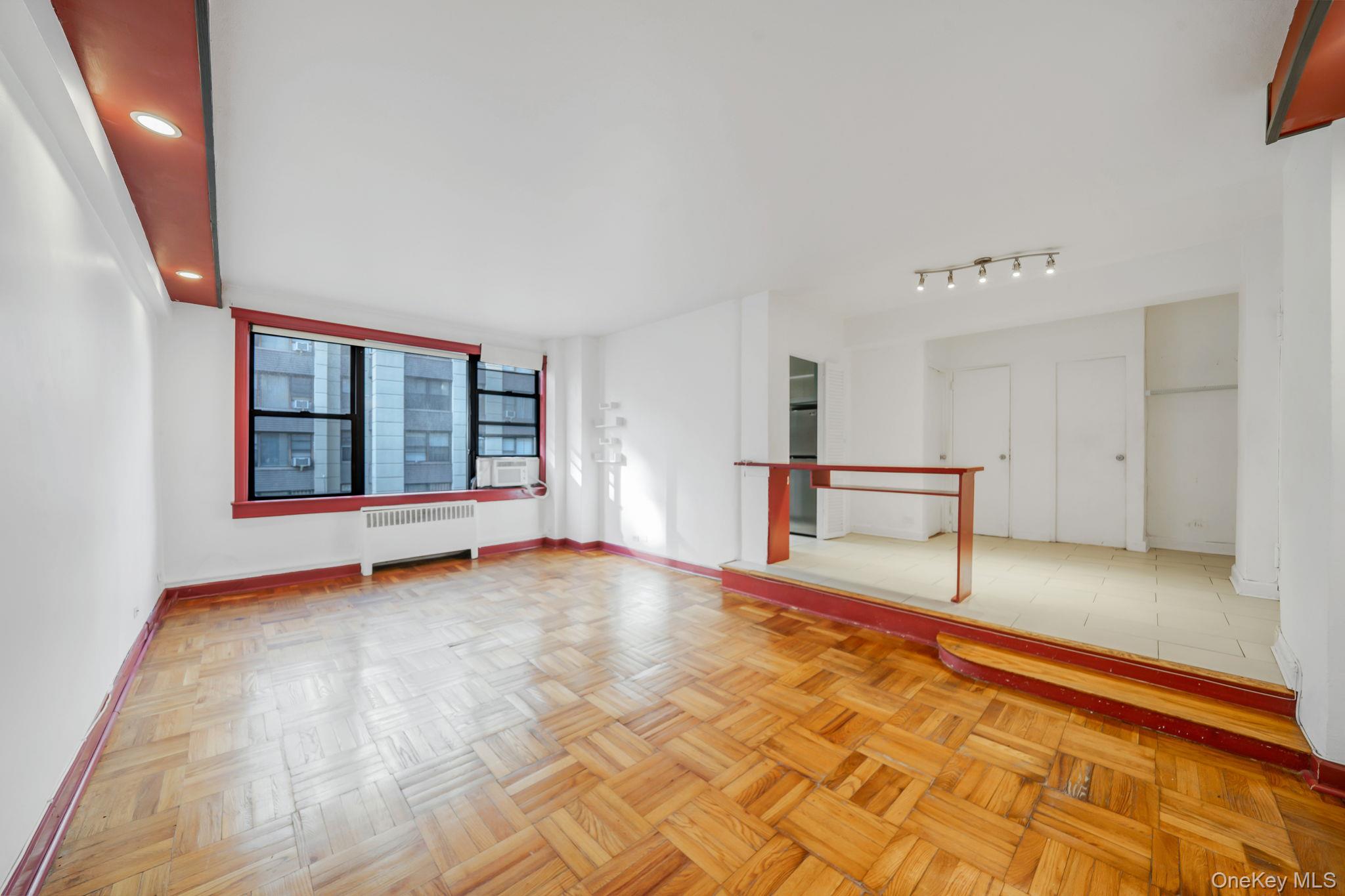 98-33 64th Avenue, Unit 1D Queens, NY 11374 - Photo 10 of 20 a view of an empty room with a window