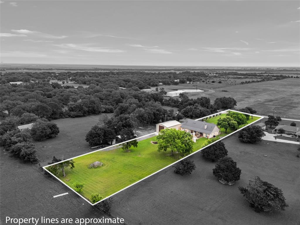 1117 Downsville Road Robinson, TX 76706 - Photo 39 of 40 Expansive property featuring a single-story residence, a detached auxiliary building, and a substantial green lawn