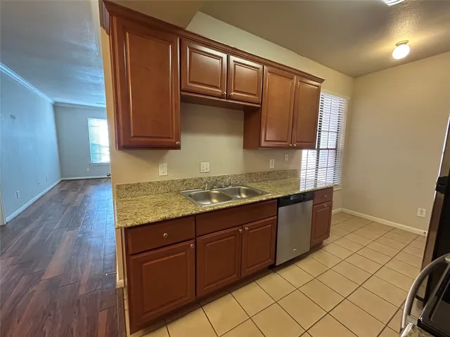 a kitchen with granite countertop cabinets and window