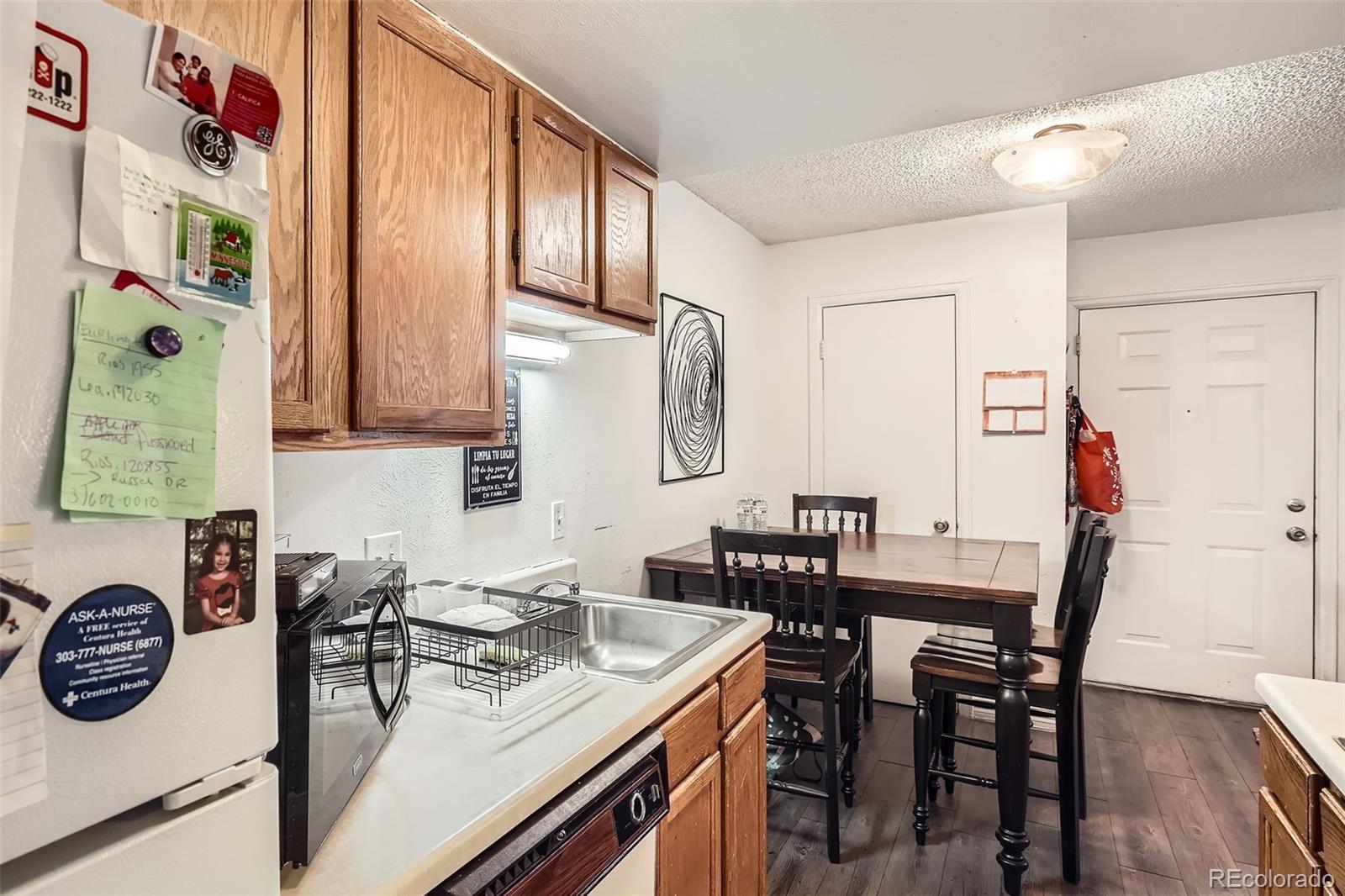 1358 South Irving Street, Unit 53 Denver, CO 80219 - Photo 11 of 28 a view of a kitchen area with furniture and wooden floor