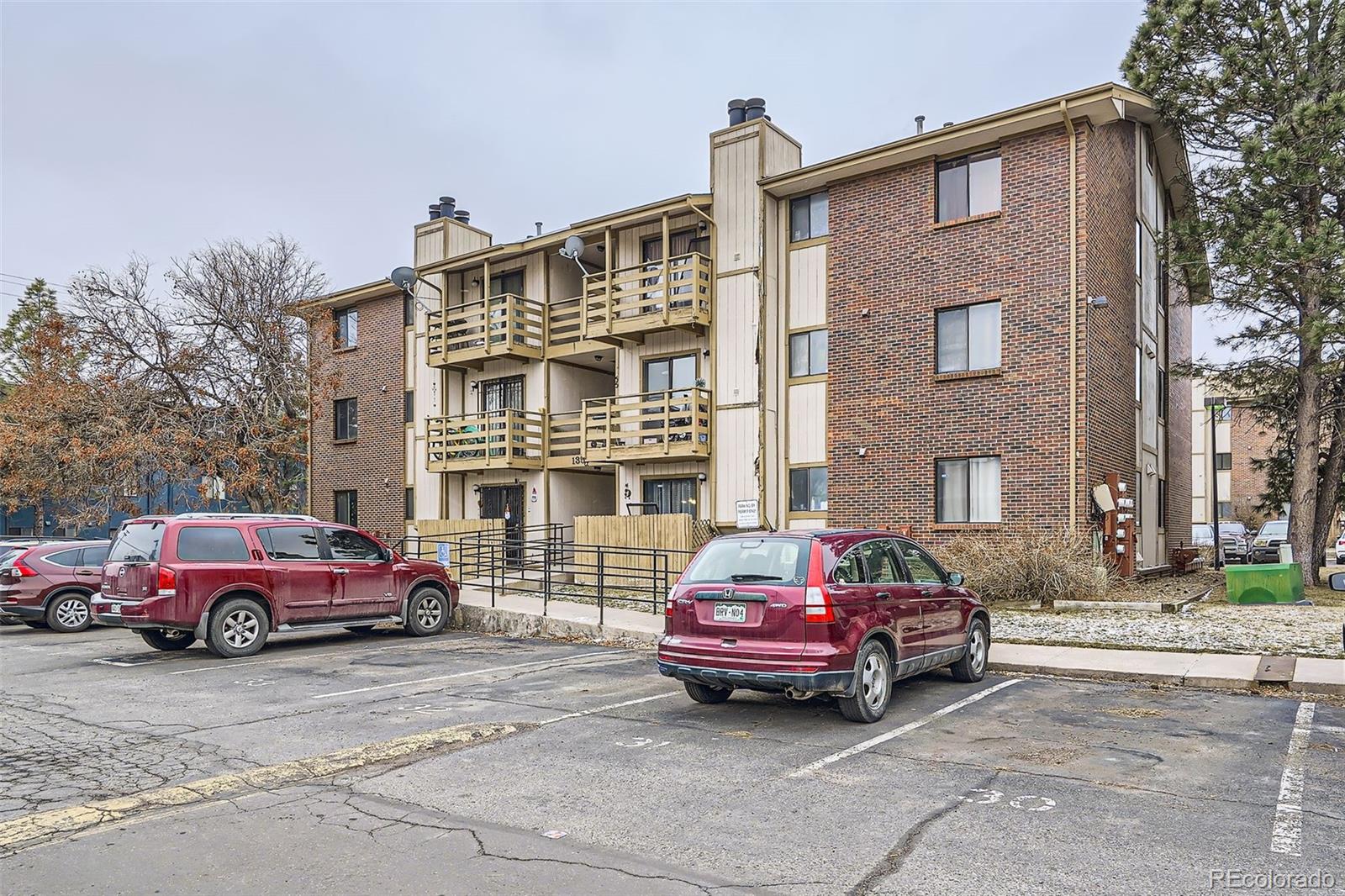 1358 South Irving Street, Unit 53 Denver, CO 80219 - Photo 2 of 28 a red car parked in front of a building