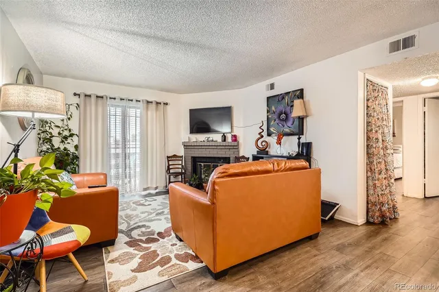 a bed room with a bed a flat screen tv and a couch