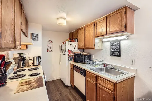 a view of a kitchen area with furniture and wooden floor