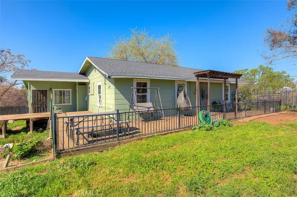 a view of a house with a yard and porch