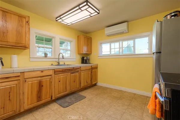 a spacious bathroom with a granite countertop sink and a window