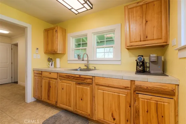 a kitchen with stainless steel appliances granite countertop a sink dishwasher and cabinets with wooden floor