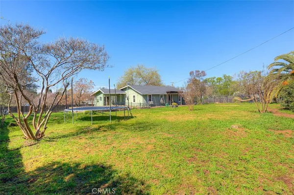 a house view with swimming pool in front of it