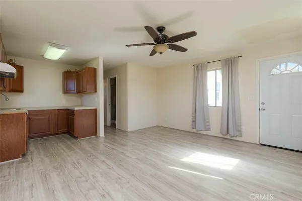 a view of a kitchen with wooden floor and a sink