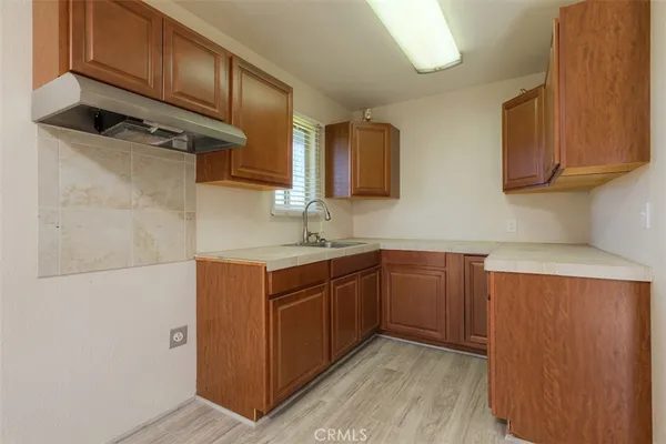 a kitchen with stainless steel appliances granite countertop wooden cabinets a sink and dishwasher