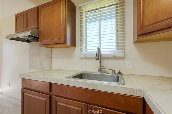 a kitchen with a sink and cabinets