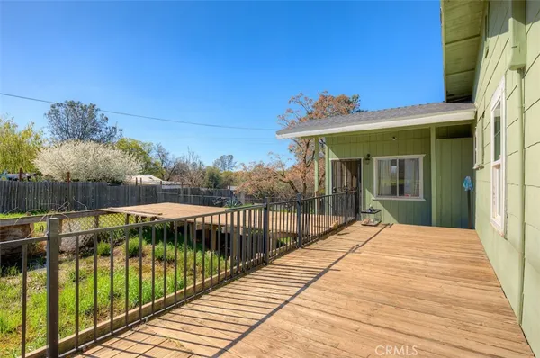 a view of a house with backyard and deck