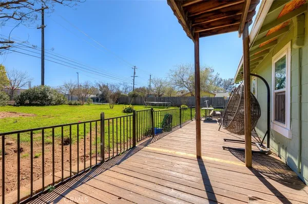 a view of a patio with chairs next to a yard