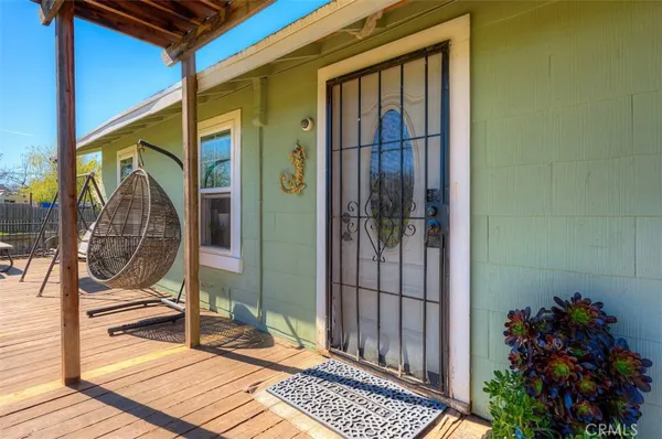 a view of a porch with a table and chairs