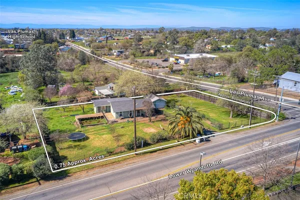 view of a balcony with two chairs and a table