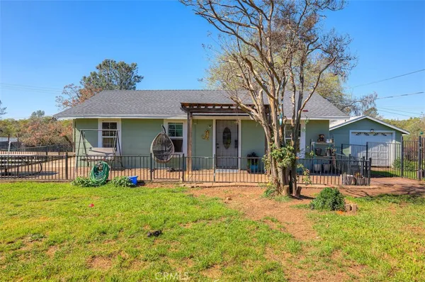 a view of a house with a backyard porch and sitting area