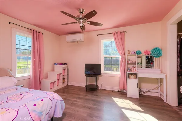 a bedroom with a bed and a tv