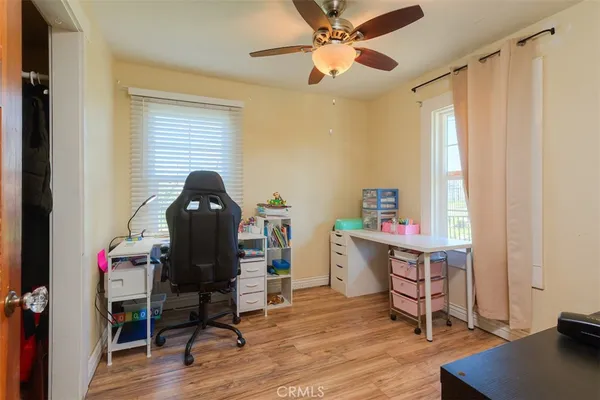 a view of a workspace with furniture and a window