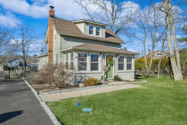 a view of a house with a yard and sitting area