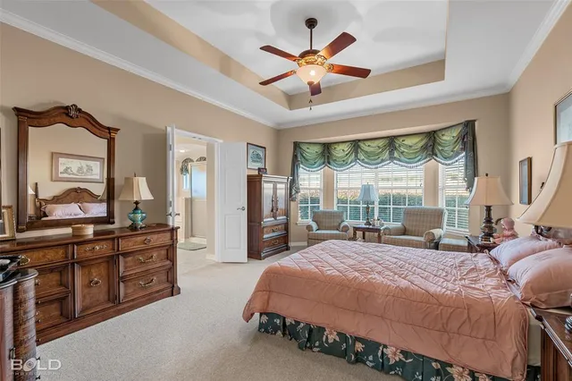 a bedroom with a large bed and a large window