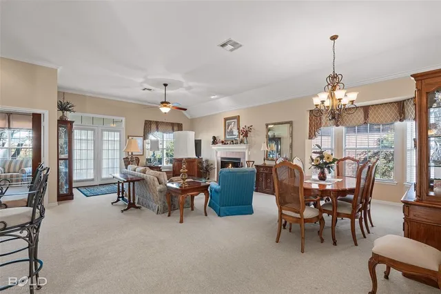 a view of a dining room and livingroom furniture and chandelier