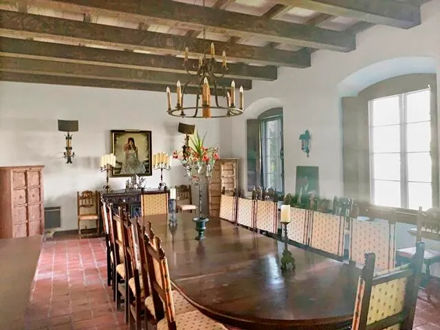 a view of a dining room with furniture a chandelier and wooden floor