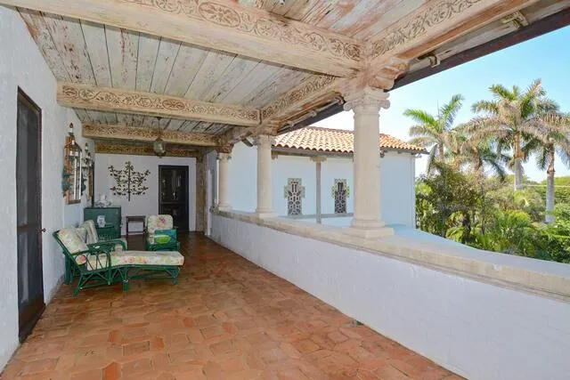 a view of a porch with furniture and a backyard