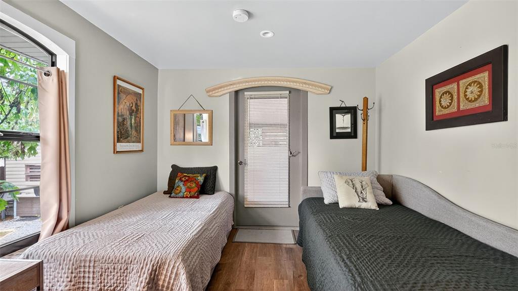 6499 Nebula Street Weeki Wachee, FL 34613 - Photo 15 of 54 a bedroom with a bed and wooden floor