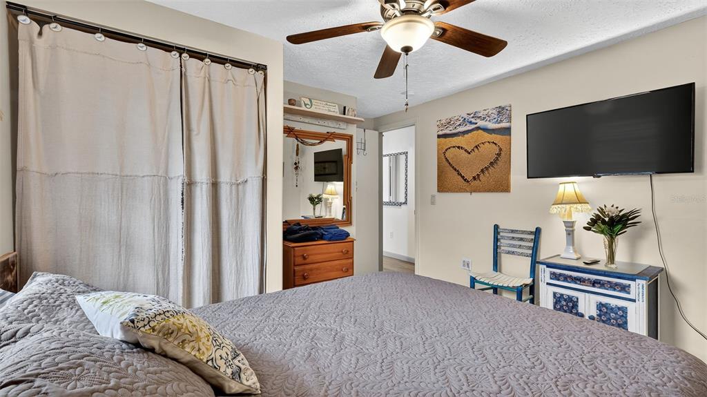 6499 Nebula Street Weeki Wachee, FL 34613 - Photo 24 of 54 a bedroom with a bed and a flat screen tv